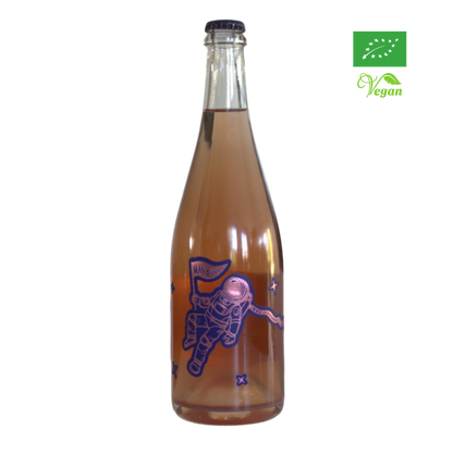 A bottle of Tenuta Demaio Man On Mars sparkling wine with a depiction of an astronaut on the label, indicating it is organic and vegan friendly.