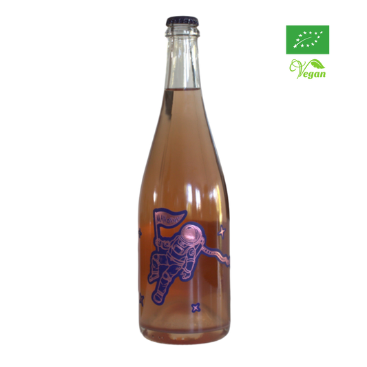 A bottle of Tenuta Demaio Man On Mars sparkling wine with a depiction of an astronaut on the label, indicating it is organic and vegan friendly.