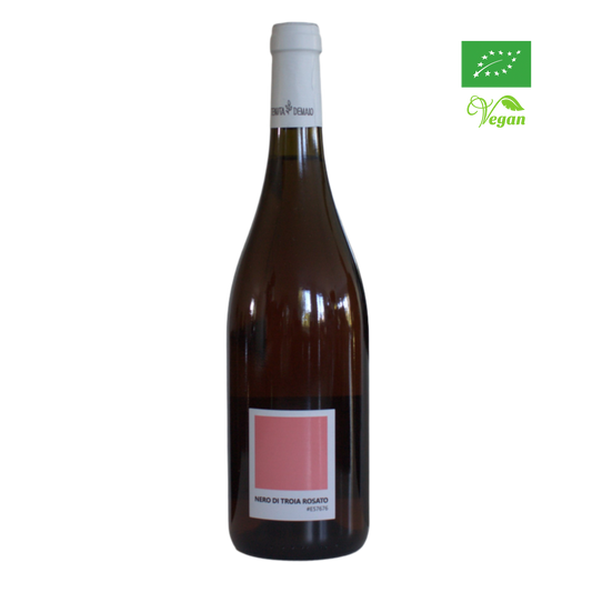 A bottle of Tenuta Demaio Nero di Troia Rosato 2022 wine with a pink label, organic certification logo, and a vegan friendly icon.