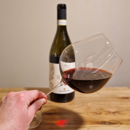 Intense Garnet Red Barolo Wine with Orange Hues in Glass