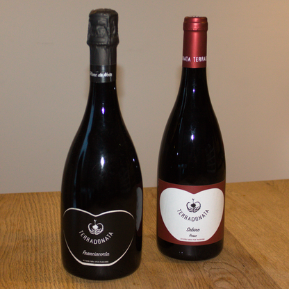 Two wine bottles from Terradonna on a wooden table